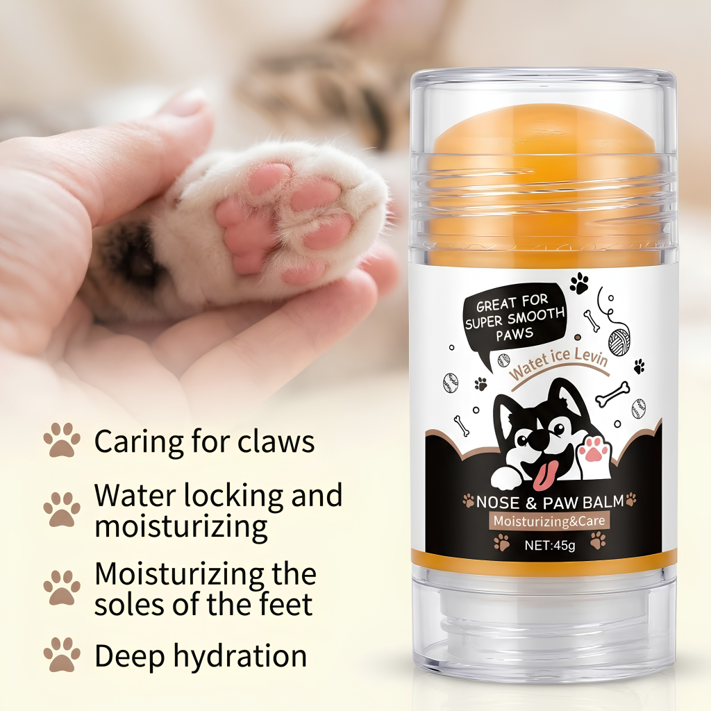 A clear plastic tube of Water Ice Levin Nose & Paw Balm with an orange-yellow balm stick and a white label featuring a cartoon dog, shown next to a hand holding a cat's paw. Text on the left lists benefits: caring for claws, water locking and moisturizing, moisturizing the soles of the feet, and deep hydration.